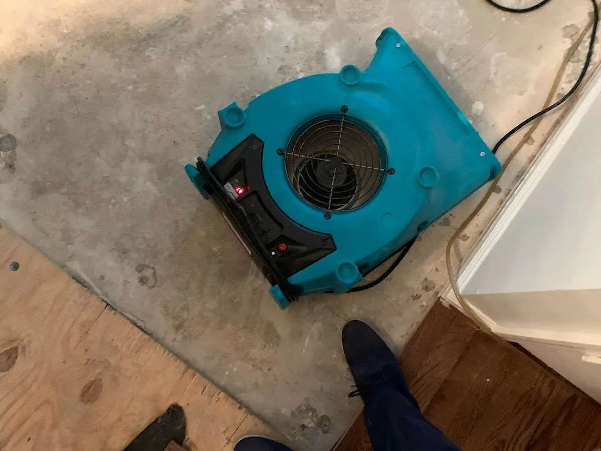 Air mover drying subfloor during Commercial Water Damage Restoration in Wooster